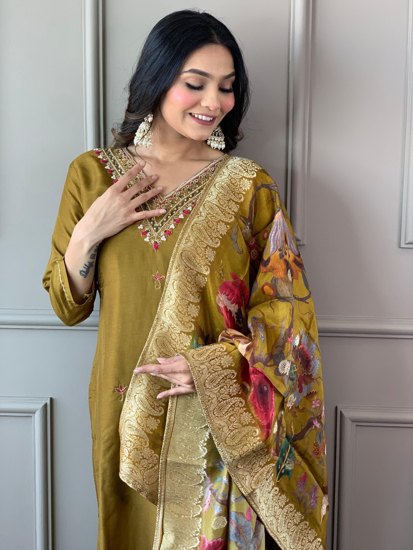 Grace meets tradition in this stunning olive-green Kurti set, adorned with delicate embroidery and a richly printed dupatta