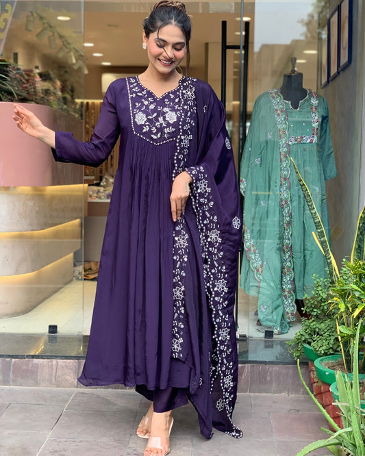 Step into elegance with this deep purple Kurti set, featuring intricate white embroidery and a gracefully flowing silhouette