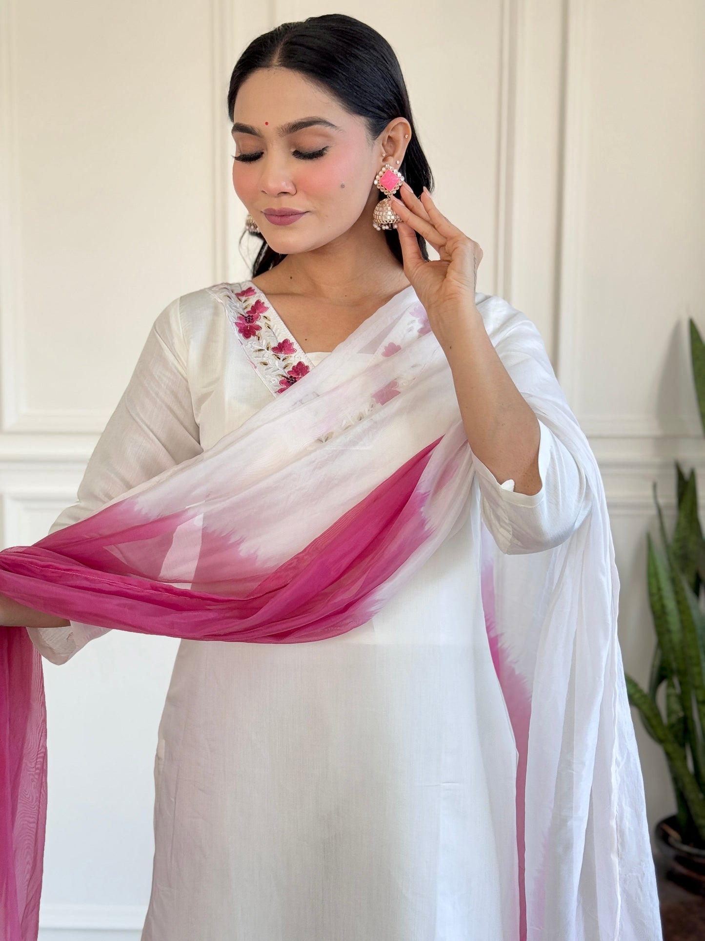 Grace meets elegance in this stunning white Kurti set, adorned with delicate floral embroidery and a soft pink ombre dupatta