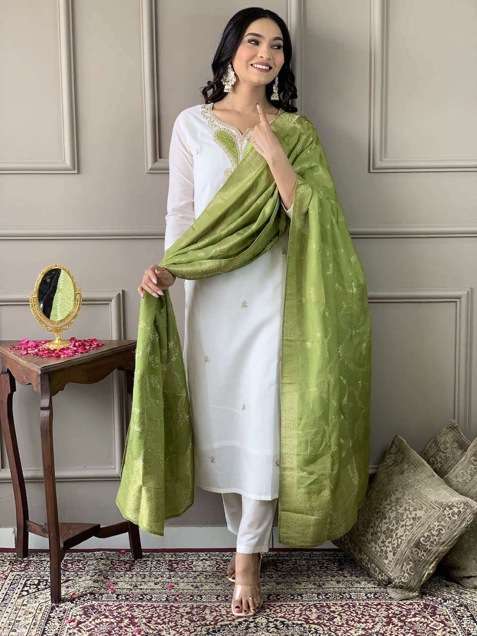 Exude grace in this pristine white Kurti set, adorned with delicate embroidery and paired with an elegant green dupatta