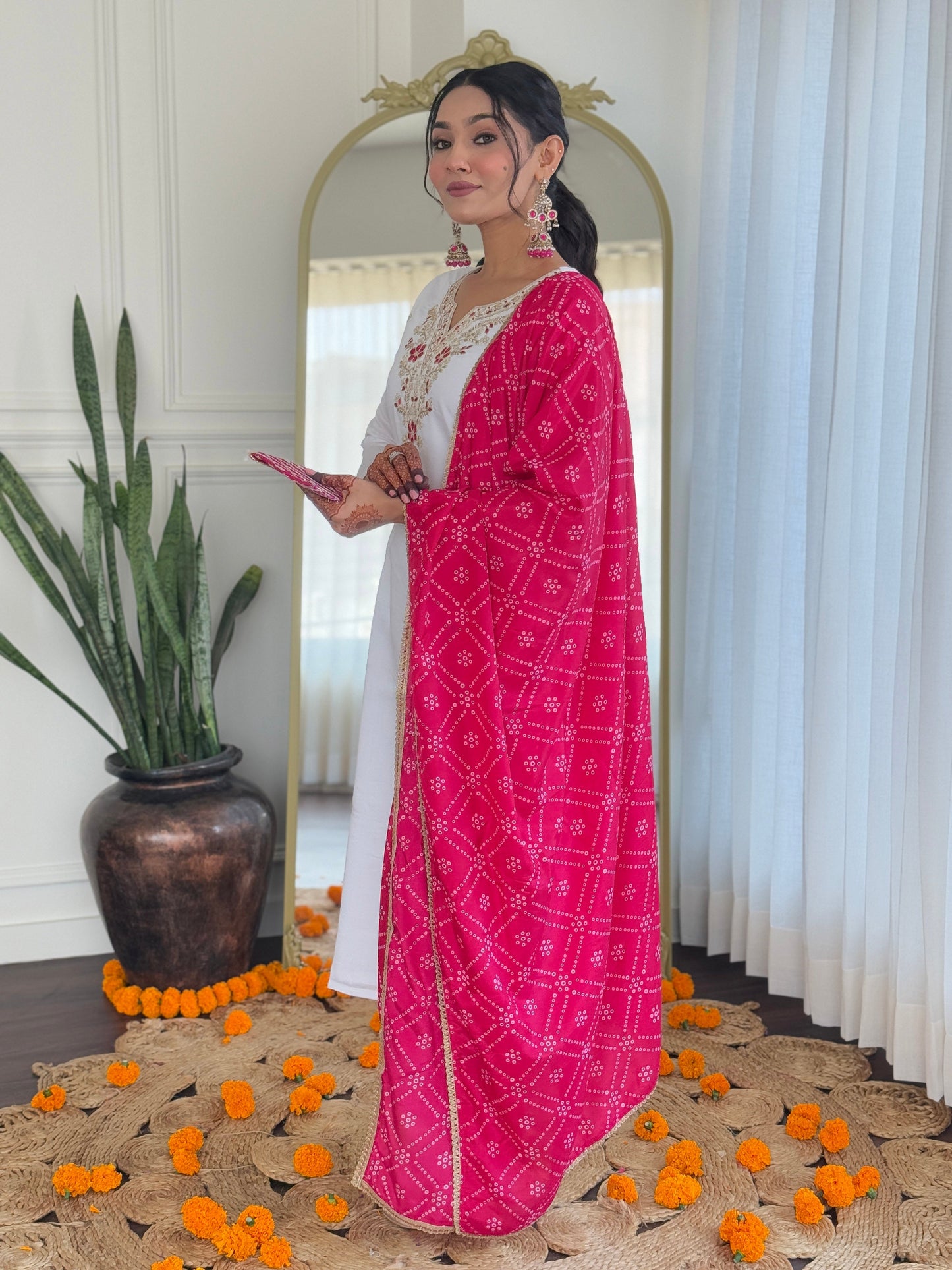 Elevate your elegance with this stunning white kurti set, adorned with intricate embroidery and paired with a vibrant pink bandhani dupatta