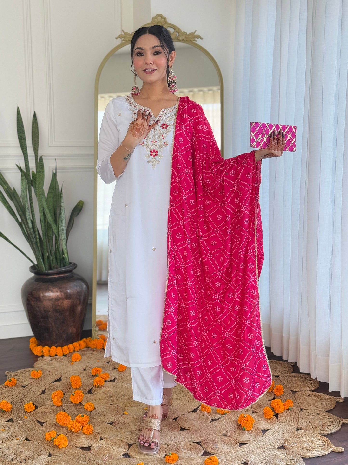 Elevate your elegance with this stunning white kurti set, adorned with intricate embroidery and paired with a vibrant pink bandhani dupatta
