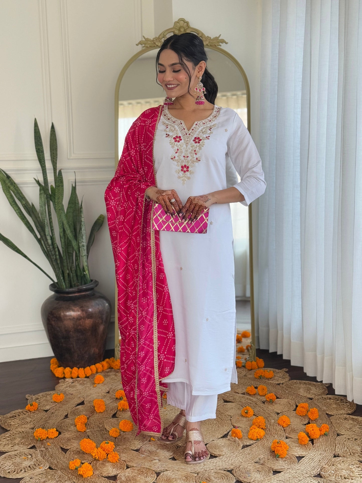Elevate your elegance with this stunning white kurti set, adorned with intricate embroidery and paired with a vibrant pink bandhani dupatta