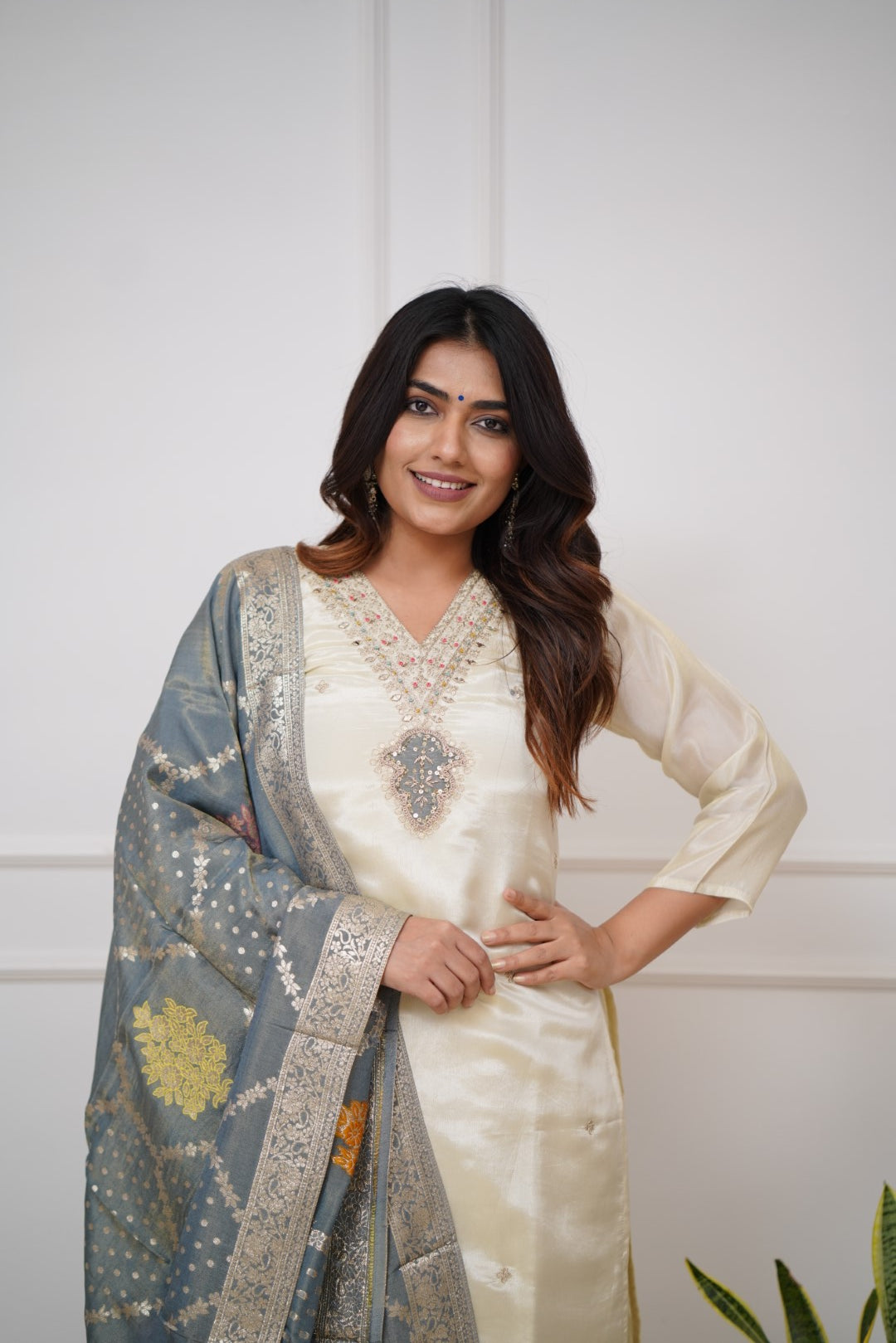 Embrace timeless elegance with this ivory kurti set, featuring delicate embellishments and a regal blue dupatta with intricate gold detailing