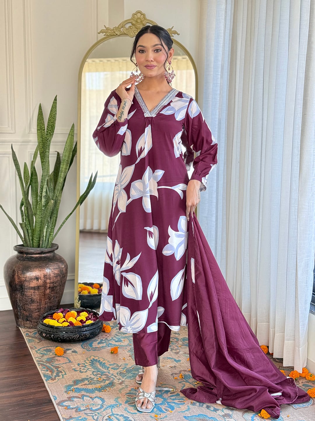 Elevate your wardrobe with this stunning maroon kurti set, adorned with bold floral prints and intricate neckline embellishments