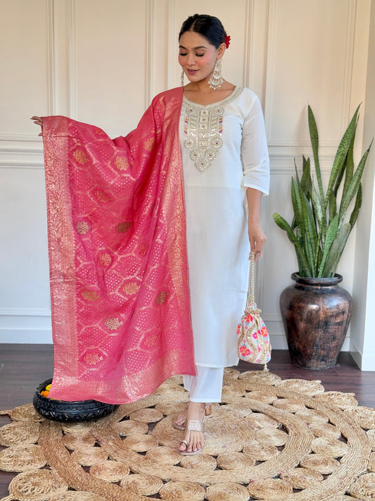 Grace meets tradition in this stunning white kurti set, highlighted with intricate embroidery and a vibrant pink Banarasi dupatta