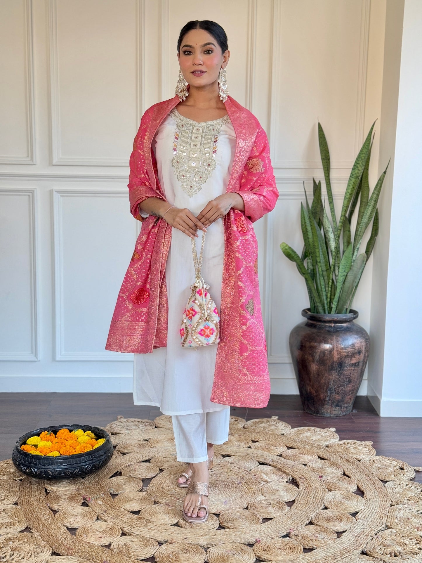 Grace meets tradition in this stunning white kurti set, highlighted with intricate embroidery and a vibrant pink Banarasi dupatta