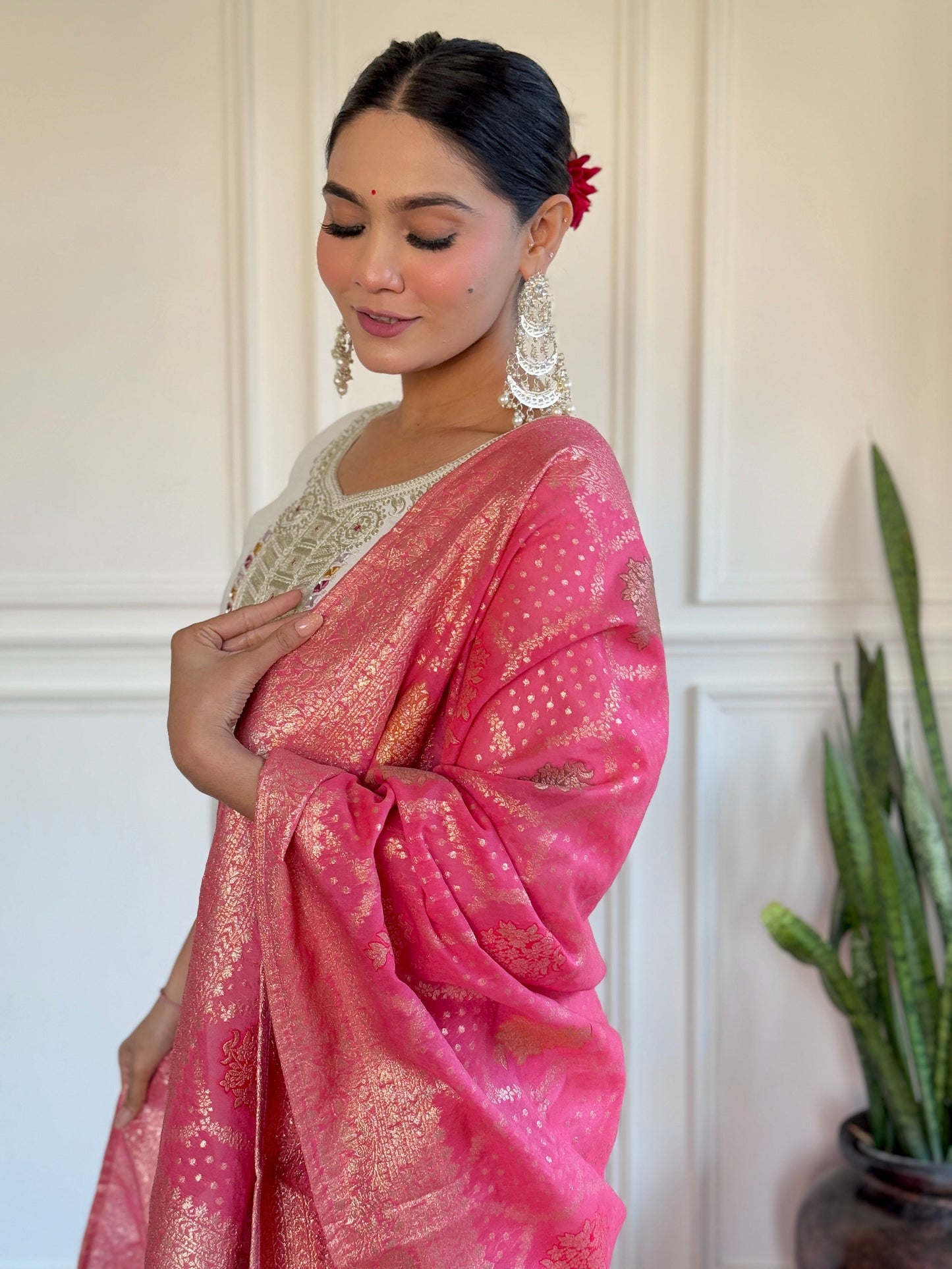 Grace meets tradition in this stunning white kurti set, highlighted with intricate embroidery and a vibrant pink Banarasi dupatta