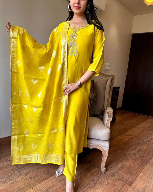 Radiate elegance in this vibrant yellow kurti set, featuring intricate embroidery on the neckline and a rich, golden-accented dupatta
