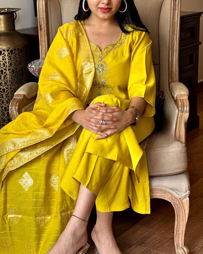 Radiate elegance in this vibrant yellow kurti set, featuring intricate embroidery on the neckline and a rich, golden-accented dupatta
