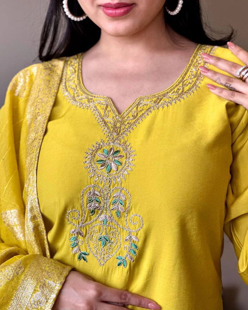 Radiate elegance in this vibrant yellow kurti set, featuring intricate embroidery on the neckline and a rich, golden-accented dupatta