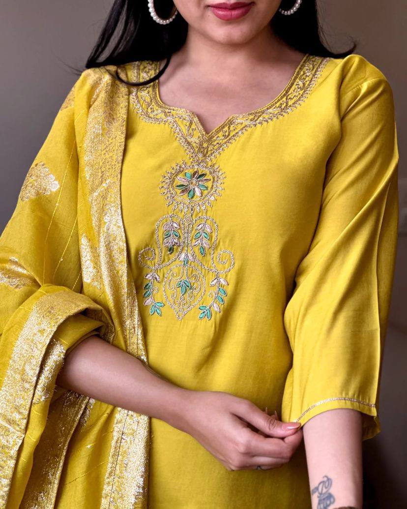 Radiate elegance in this vibrant yellow kurti set, featuring intricate embroidery on the neckline and a rich, golden-accented dupatta