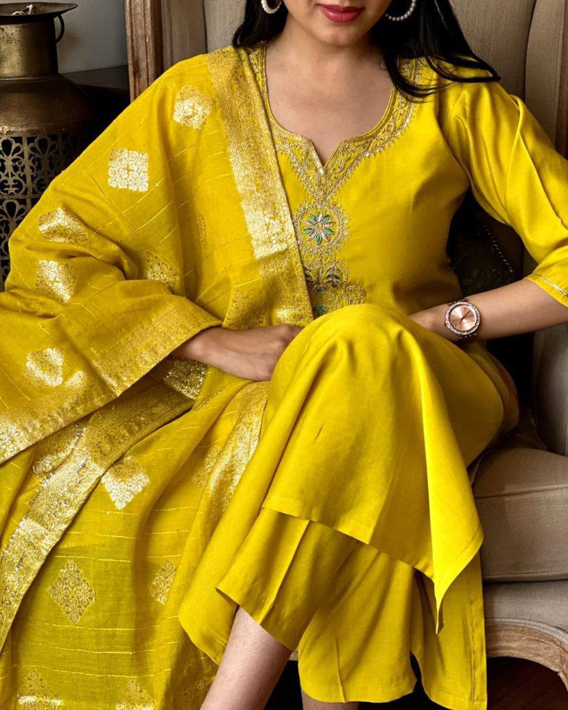 Radiate elegance in this vibrant yellow kurti set, featuring intricate embroidery on the neckline and a rich, golden-accented dupatta