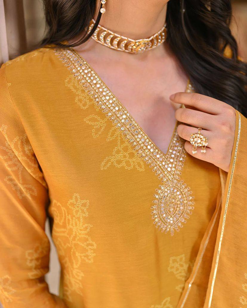 Radiate grace in this mustard yellow kurti set, adorned with intricate embroidery and a beautifully patterned dupatta