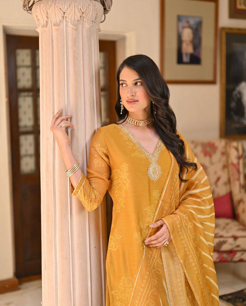 Radiate grace in this mustard yellow kurti set, adorned with intricate embroidery and a beautifully patterned dupatta