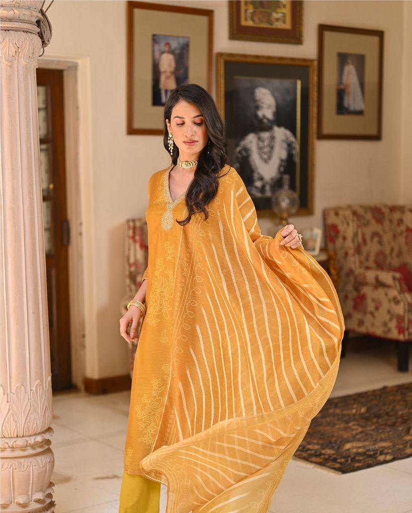 Radiate grace in this mustard yellow kurti set, adorned with intricate embroidery and a beautifully patterned dupatta