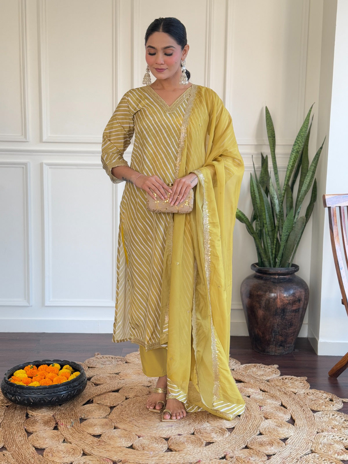Radiate elegance in this mustard yellow kurti set, adorned with classic stripes and delicate golden detailing