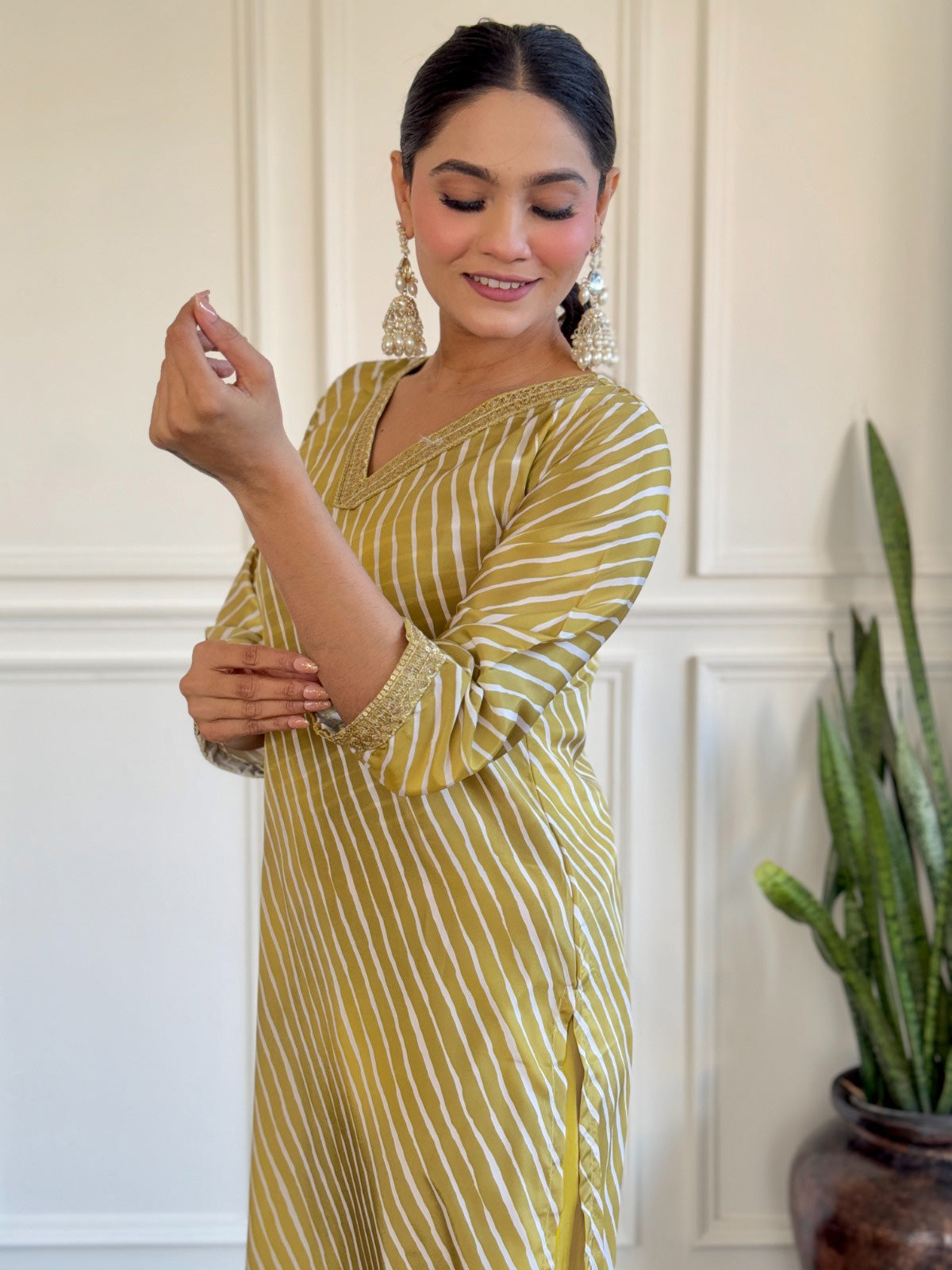 Radiate elegance in this mustard yellow kurti set, adorned with classic stripes and delicate golden detailing