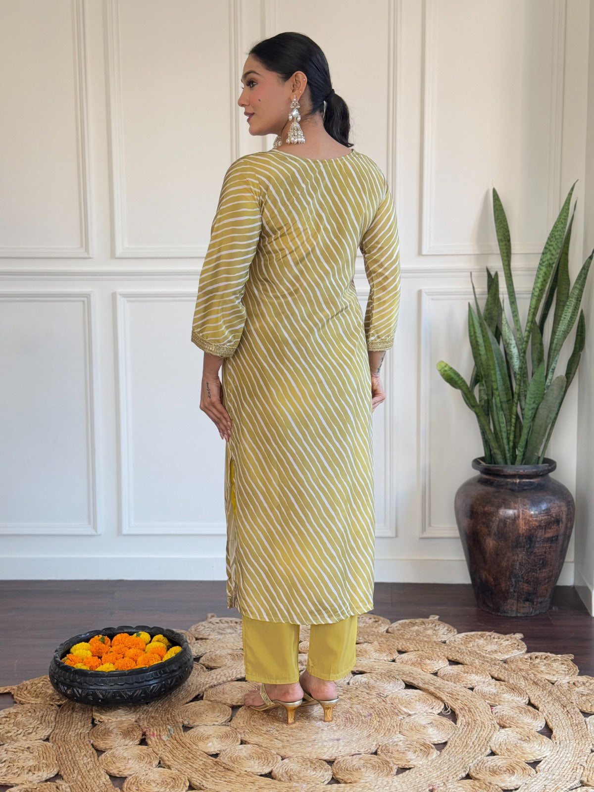 Radiate elegance in this mustard yellow kurti set, adorned with classic stripes and delicate golden detailing