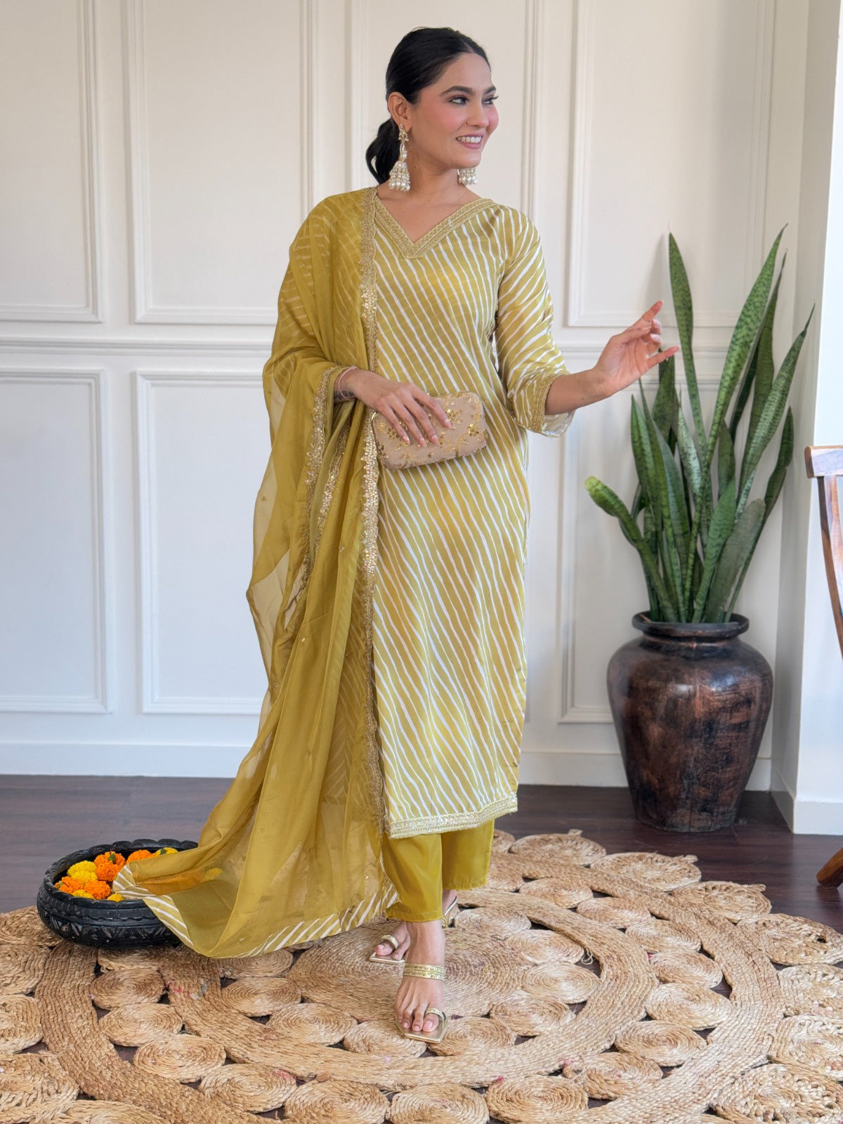 Radiate elegance in this mustard yellow kurti set, adorned with classic stripes and delicate golden detailing