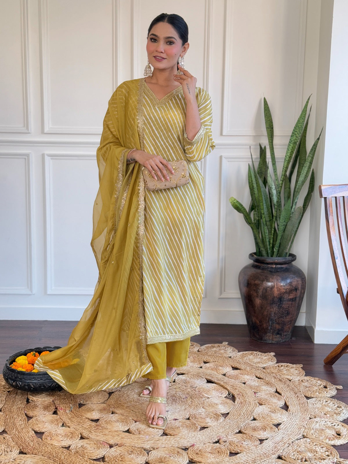Radiate elegance in this mustard yellow kurti set, adorned with classic stripes and delicate golden detailing