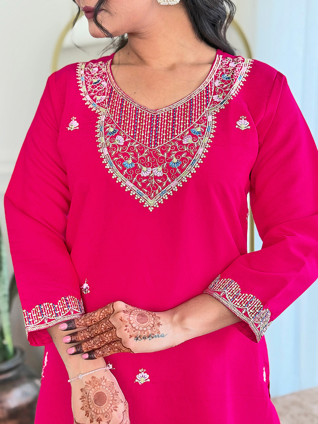 Step into elegance with this vibrant pink kurti set, adorned with delicate embellishments and a multicolored bandhani dupatta