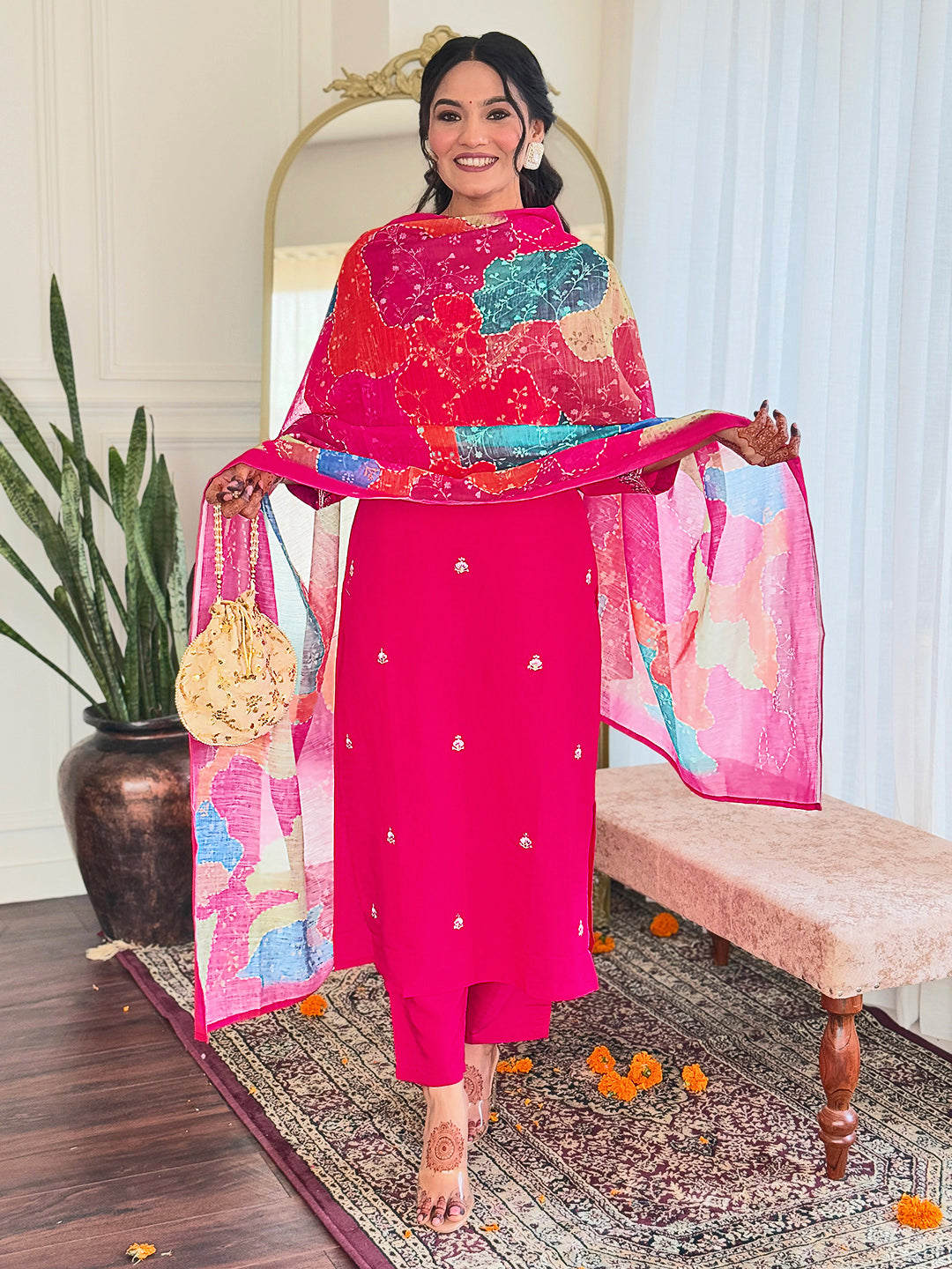 Step into elegance with this vibrant pink kurti set, adorned with delicate embellishments and a multicolored bandhani dupatta