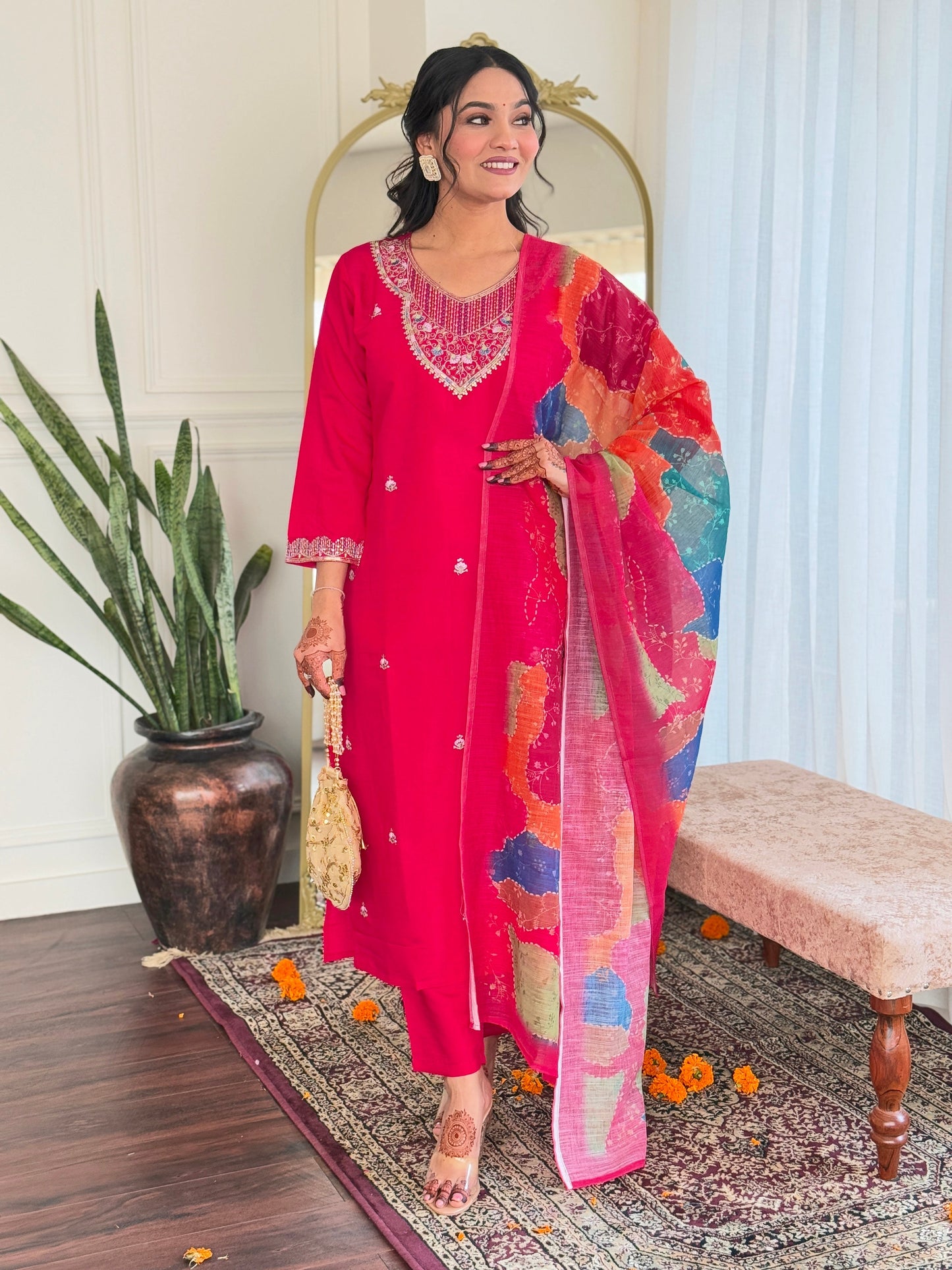 Step into elegance with this vibrant pink kurti set, adorned with delicate embellishments and a multicolored bandhani dupatta