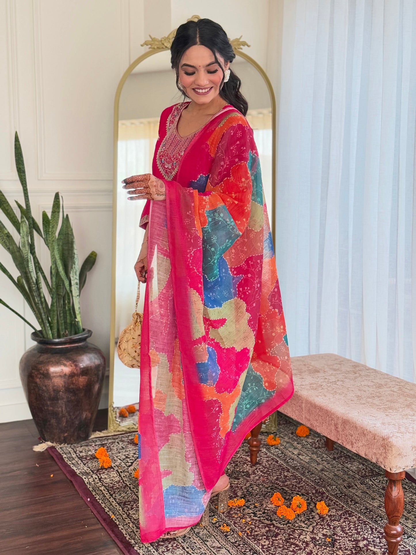 Step into elegance with this vibrant pink kurti set, adorned with delicate embellishments and a multicolored bandhani dupatta
