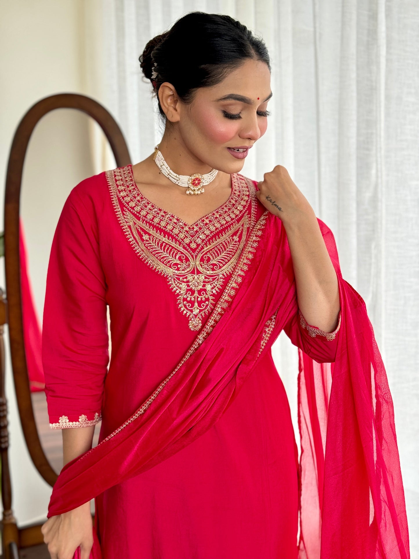 Make a bold statement with this stunning red kurti set, featuring intricate gold embroidery and a luxurious silk dupatta