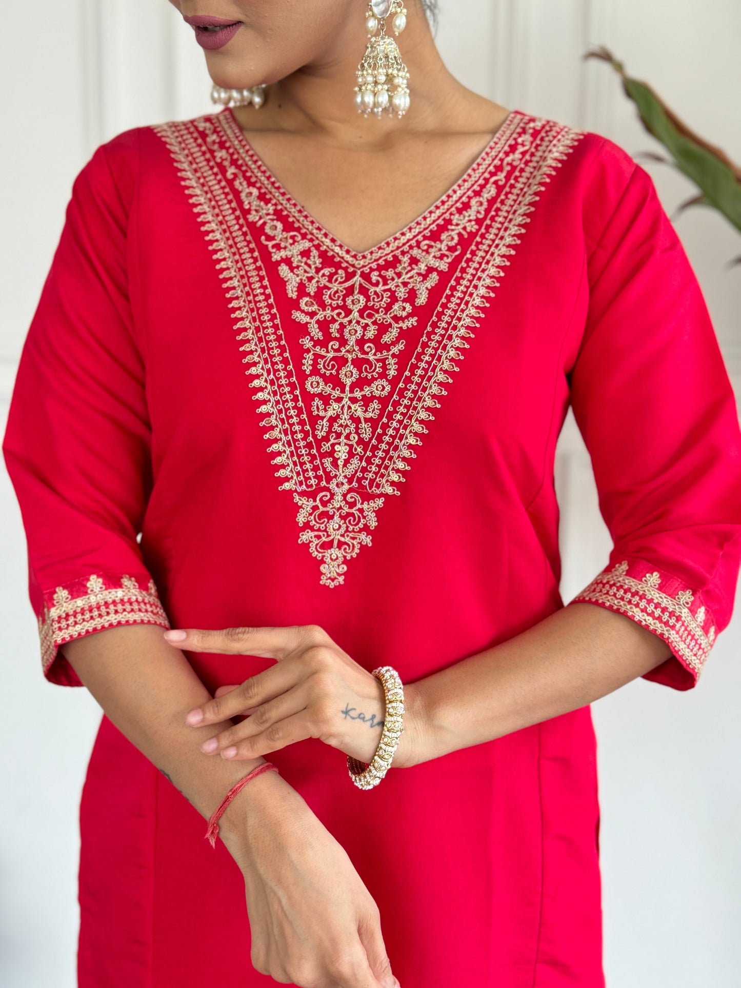 Turn heads in this stunning red kurti set, featuring intricate gold embroidery for a regal touch