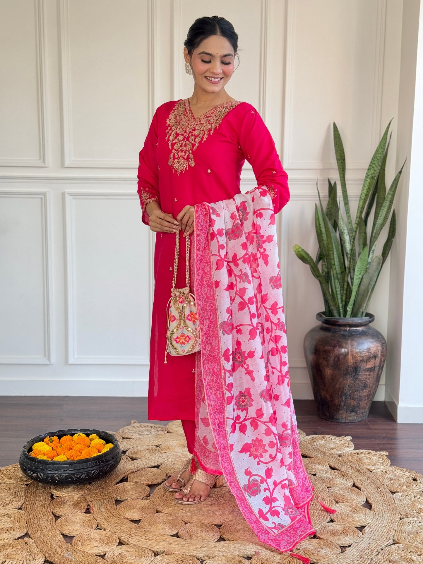 Radiate elegance in this vibrant pink kurti set, featuring exquisite gold embroidery and a beautifully printed floral dupatta