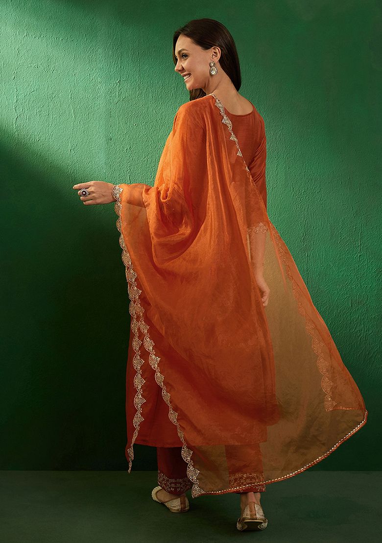 Radiate elegance in this rust-orange kurti set, adorned with intricate embroidery and a sheer embellished dupatta