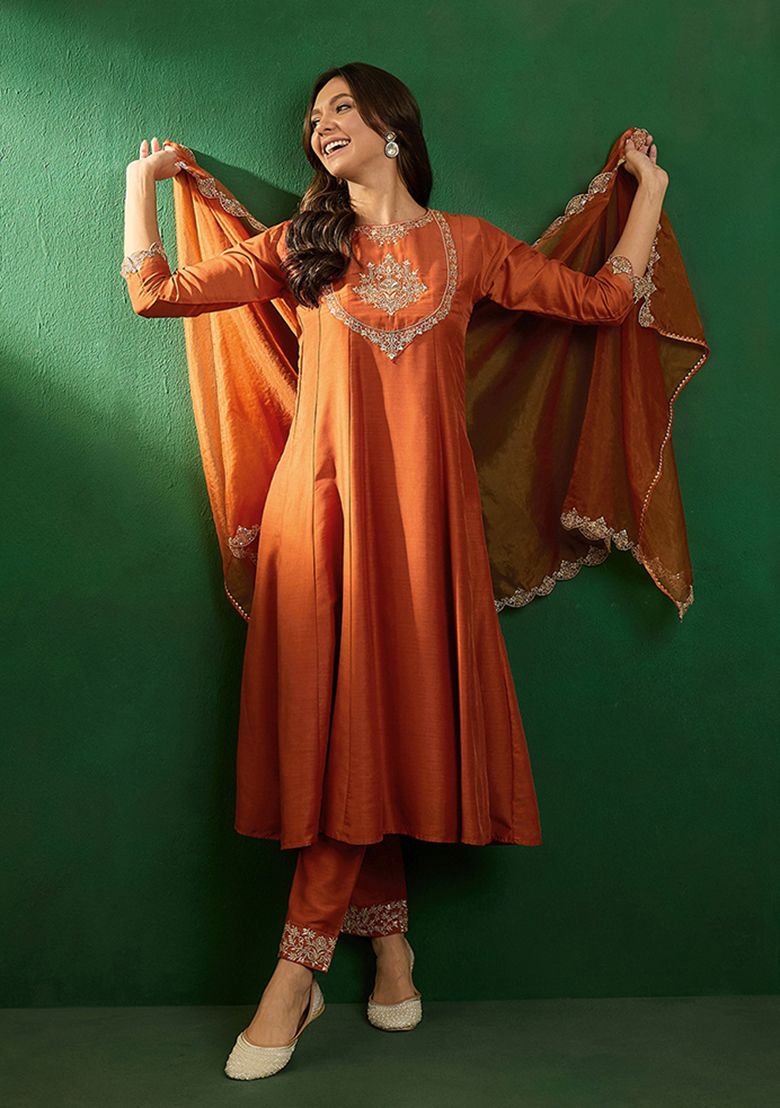Radiate elegance in this rust-orange kurti set, adorned with intricate embroidery and a sheer embellished dupatta