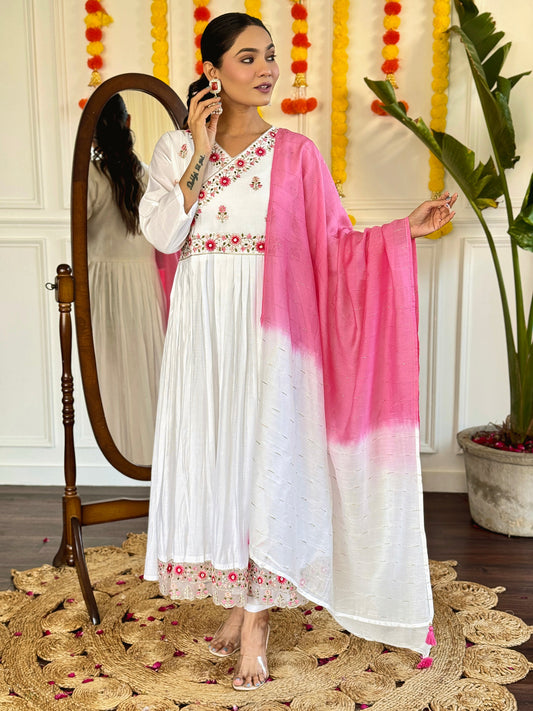 Grace meets elegance in this ethereal white Anarkali set, adorned with delicate floral embroidery and a stunning pink ombre dupatta