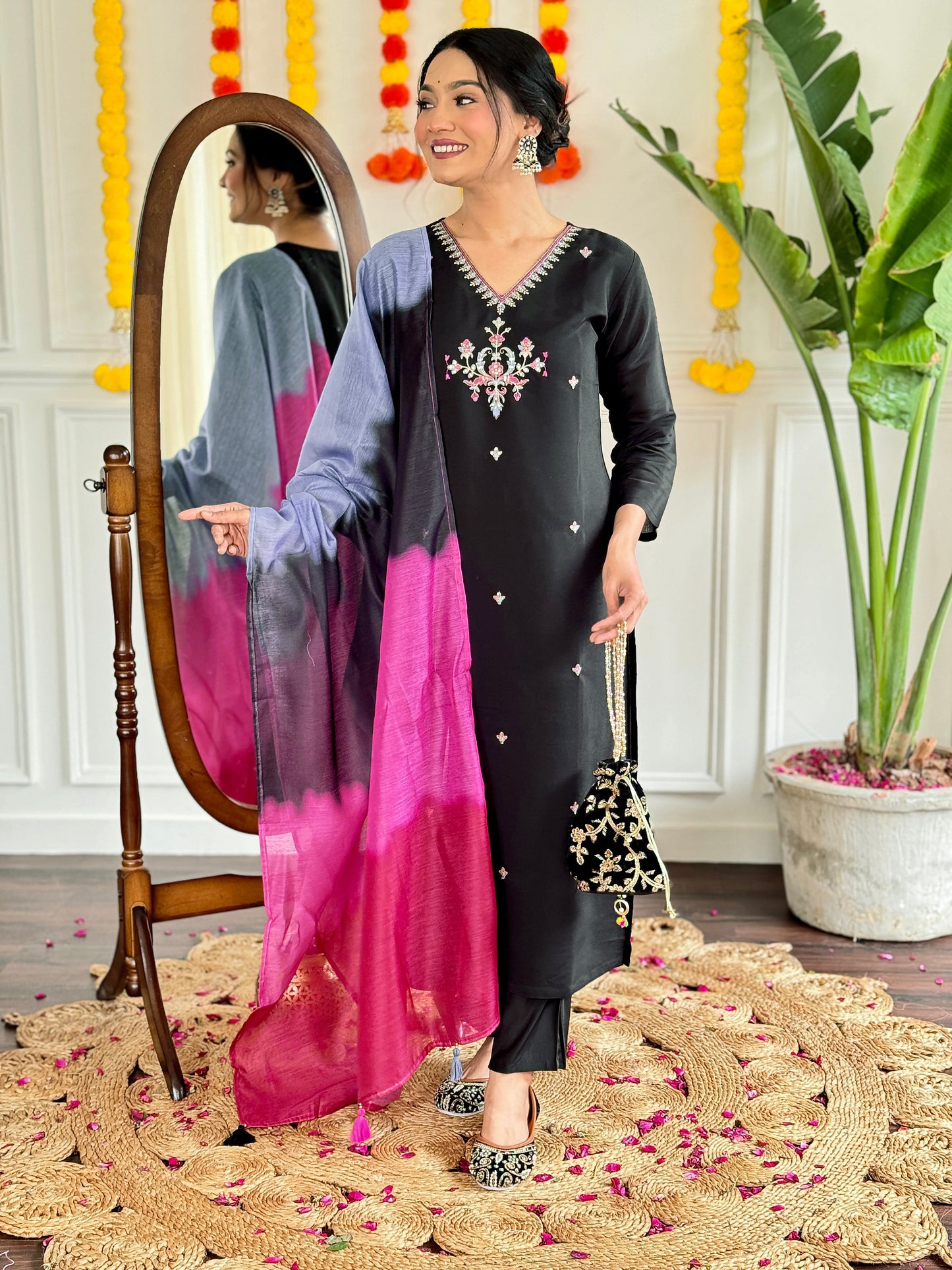 Make a bold statement with this stunning black kurti set, featuring intricate embroidery and a striking ombre dupatta in shades of pink and grey