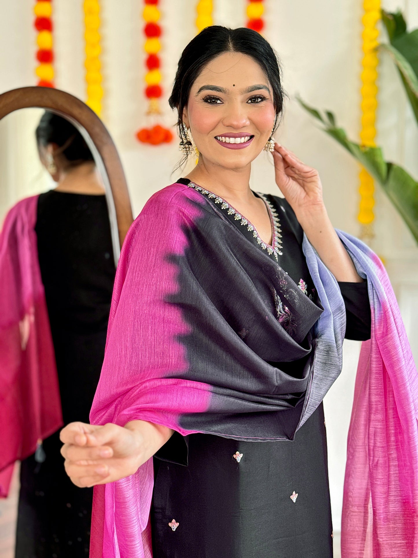 Make a bold statement with this stunning black kurti set, featuring intricate embroidery and a striking ombre dupatta in shades of pink and grey