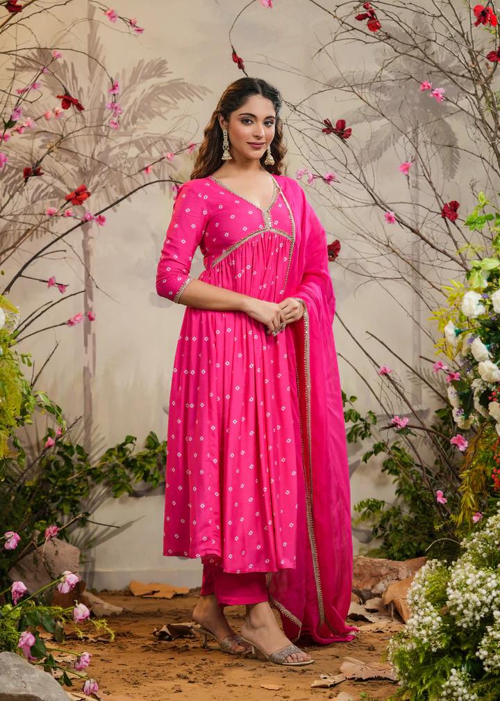 Turn heads in this stunning pink kurti set, featuring delicate mirror work and intricate detailing. Paired with a flowy dupatta and comfortable bottoms