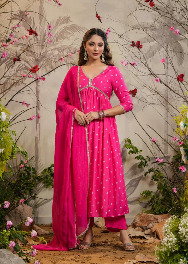 Turn heads in this stunning pink kurti set, featuring delicate mirror work and intricate detailing. Paired with a flowy dupatta and comfortable bottoms