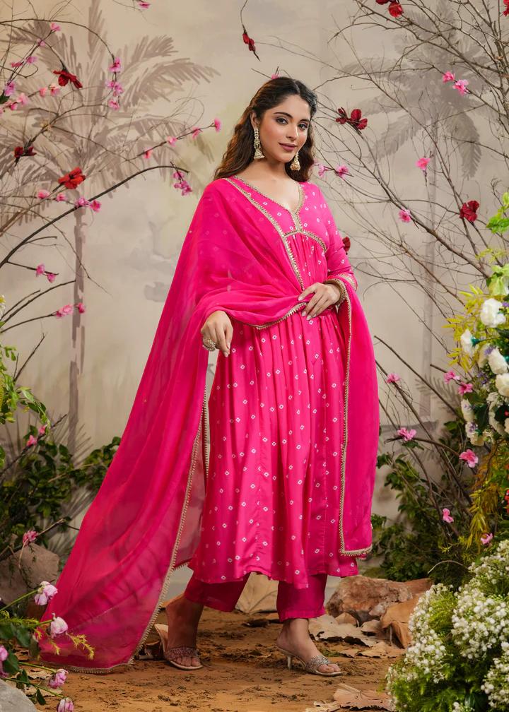 Turn heads in this stunning pink kurti set, featuring delicate mirror work and intricate detailing. Paired with a flowy dupatta and comfortable bottoms