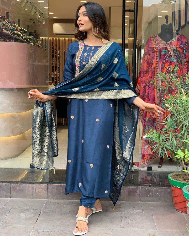 Make a statement with this stunning navy blue kurti set, featuring intricate embroidery and a gracefully adorned dupatta