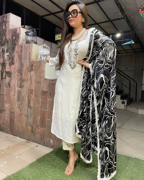 Make a bold statement with this stunning white kurti set, elegantly adorned with intricate embellishments