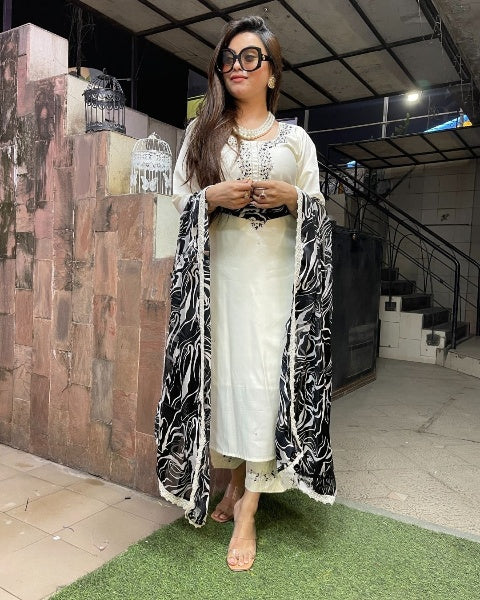 Make a bold statement with this stunning white kurti set, elegantly adorned with intricate embellishments