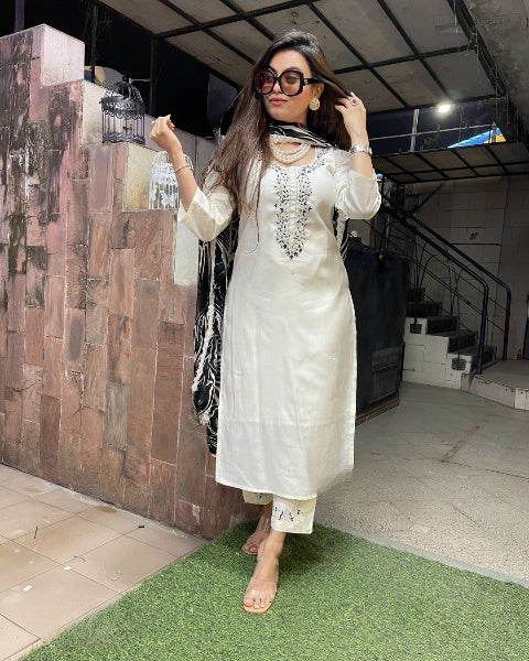 Make a bold statement with this stunning white kurti set, elegantly adorned with intricate embellishments