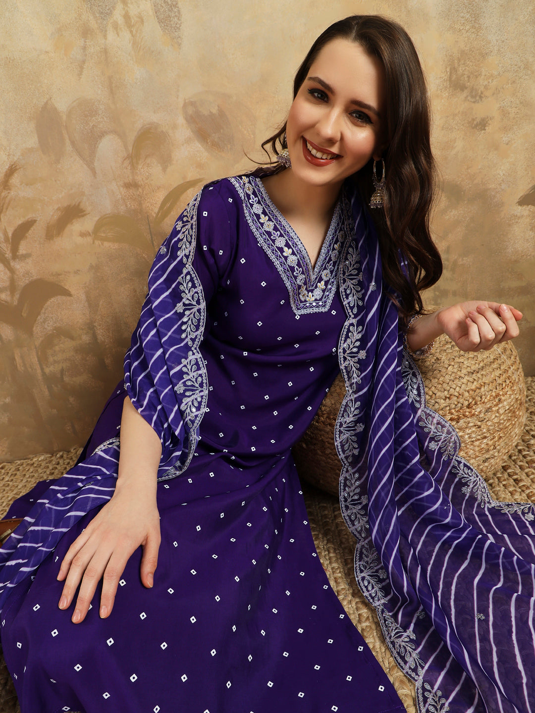 Embrace elegance with this regal purple kurti set, adorned with intricate embroidery and paired with a beautifully striped and embroidered dupatta