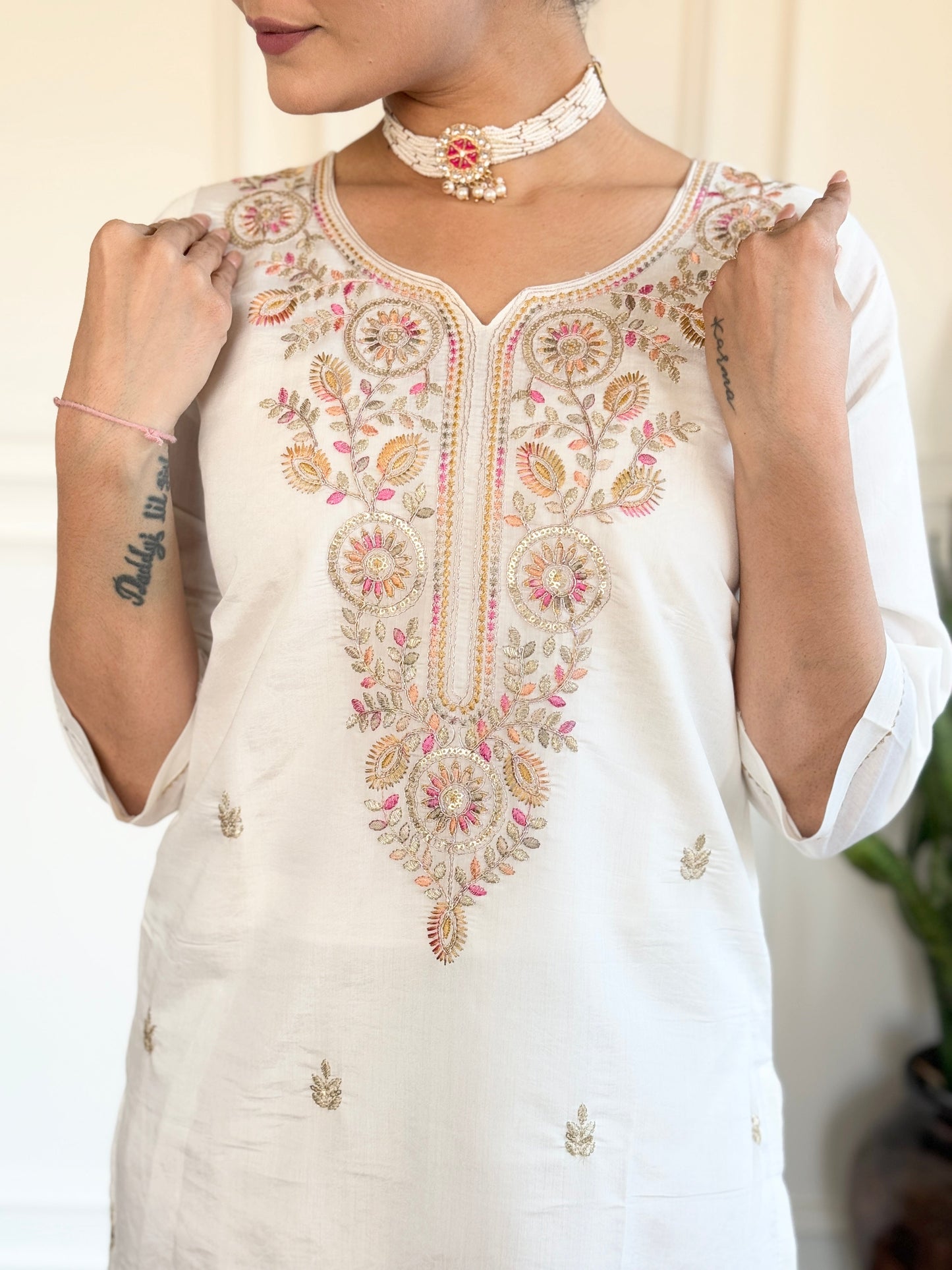 Embrace elegance with this serene white kurti set, adorned with delicate pastel embroidery and a floral-printed blue dupatta