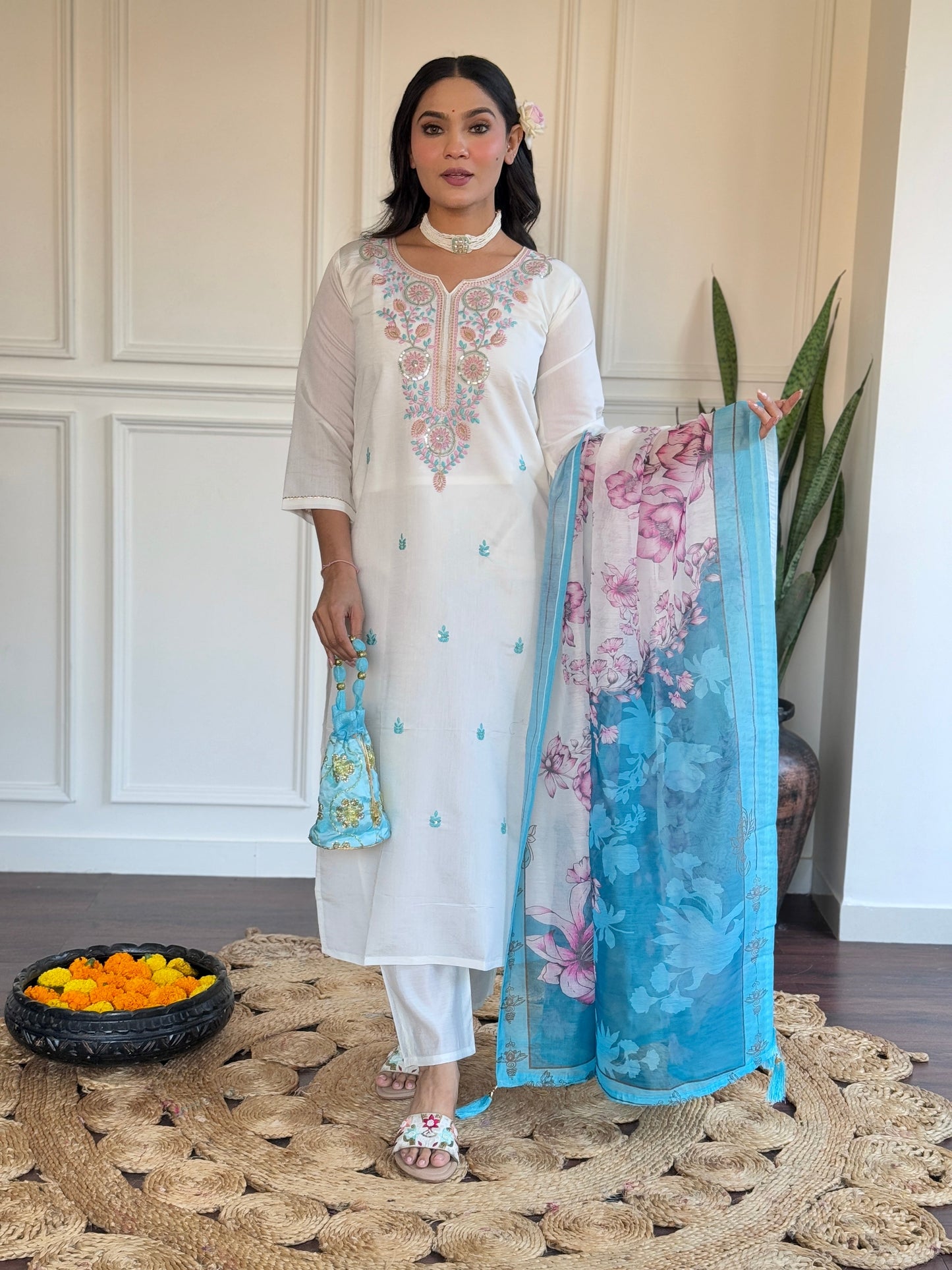 Embrace elegance with this serene white kurti set, adorned with delicate pastel embroidery and a floral-printed blue dupatta