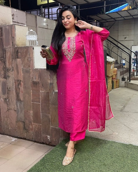 Drape yourself in elegance with this vibrant pink kurti set, adorned with delicate embellishments and a stunning embroidered neckline