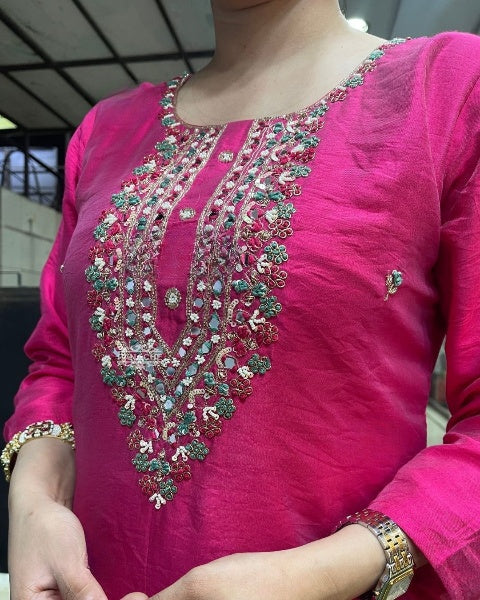 Drape yourself in elegance with this vibrant pink kurti set, adorned with delicate embellishments and a stunning embroidered neckline