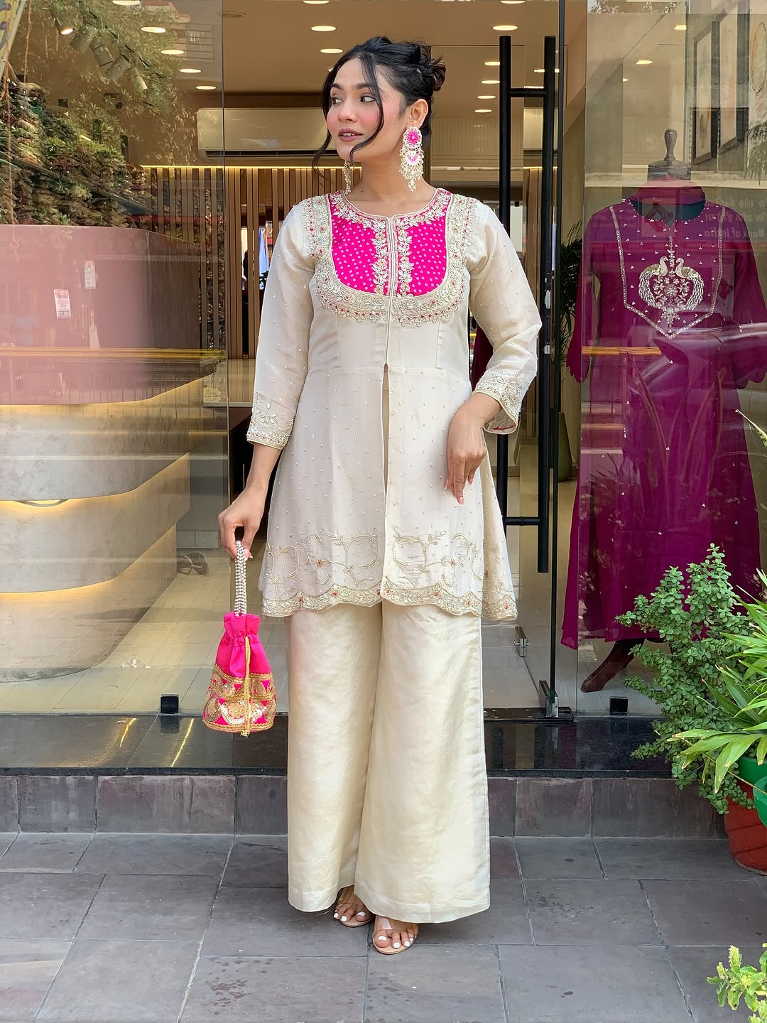 Elevate your ethnic style with this elegant cream kurti set featuring intricate embroidery and a striking purple yoke. Paired with flared pants, this outfit blends tradition with modern flair—perfect for festive occasions or graceful daywear.